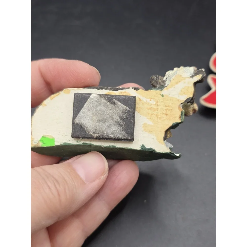 This collection features various vintage-style cow refrigerator magnets